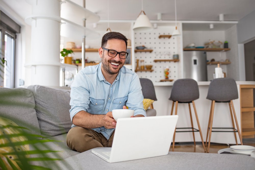 Amazon Virtual Jobs: a young man working from home with his laptop