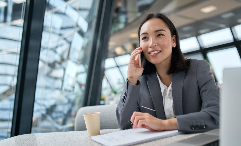 Land Remote Marketing Jobs for Beginners: A happy young lady making phone call