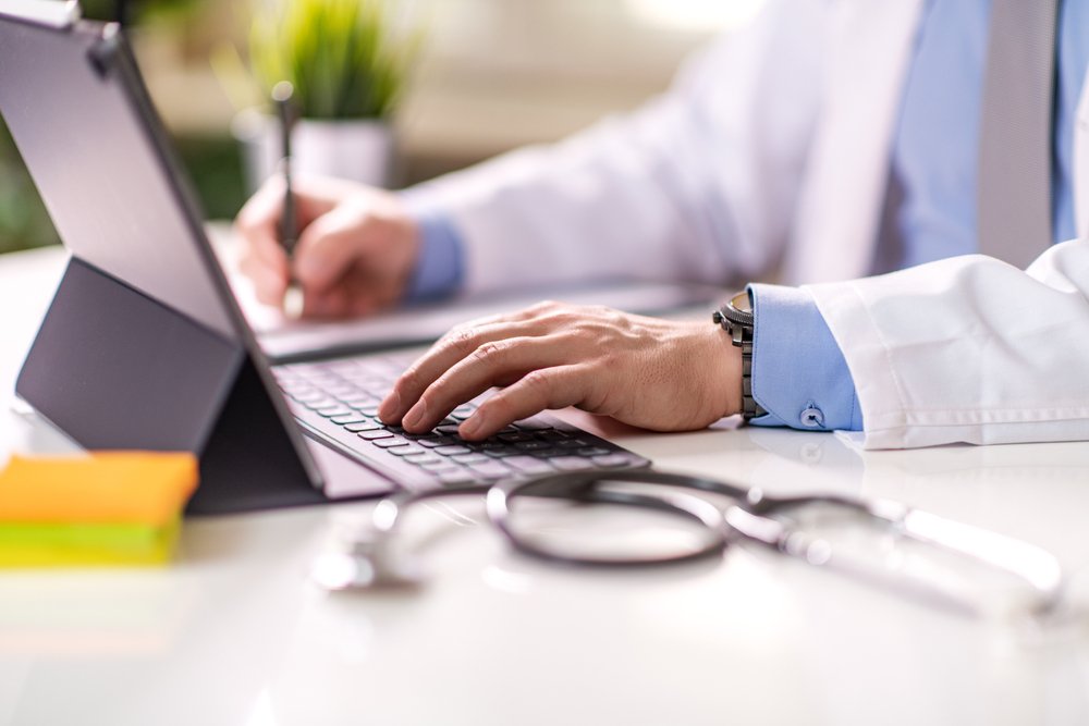 Remote Job Opportunities in Healthcare: Close-up of a doctor using a laptop in his office. Healthcare concept.