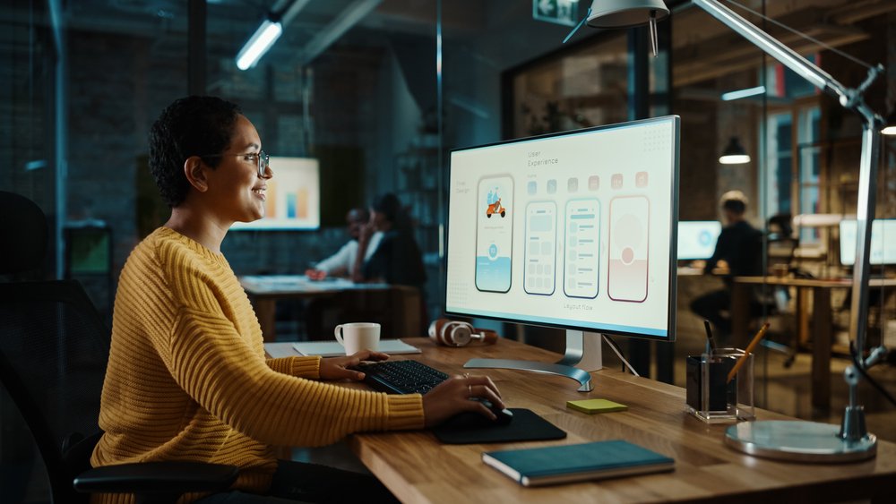 Top Paying Remote Jobs: Beautiful Diverse Multiethnic Female is Developing a New App Design and User Interface in a Digital Graphics Editing Software. 