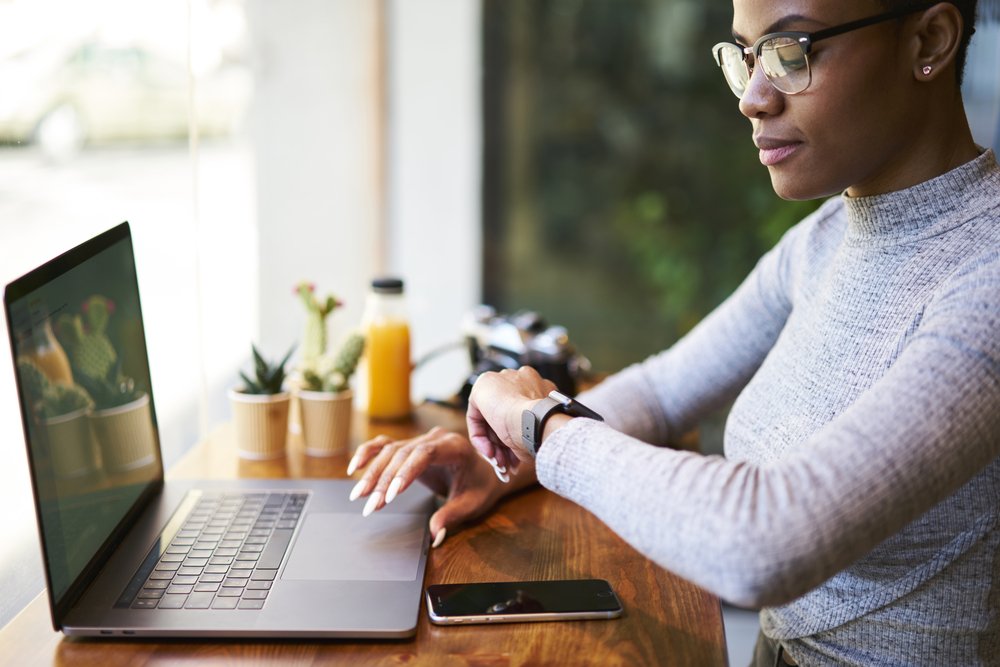Work from Home Jobs Hiring: Picture of a lady working remotely and checking her time