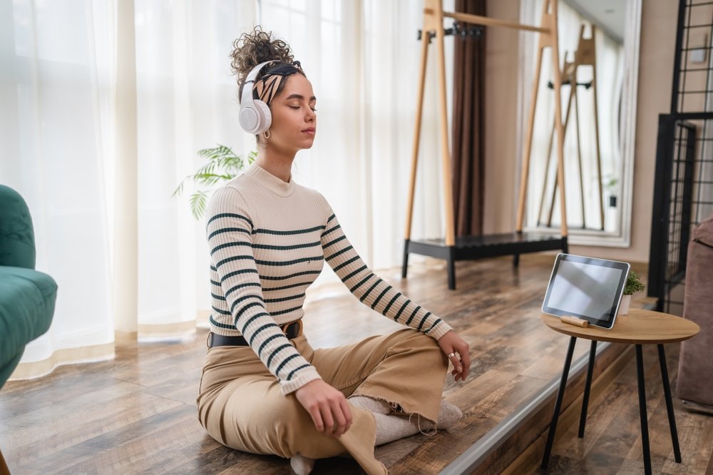 How To Avoid Distractions and Stay Focused When Working Remotely: Picture of a lady doing exercise after working remotely all day.