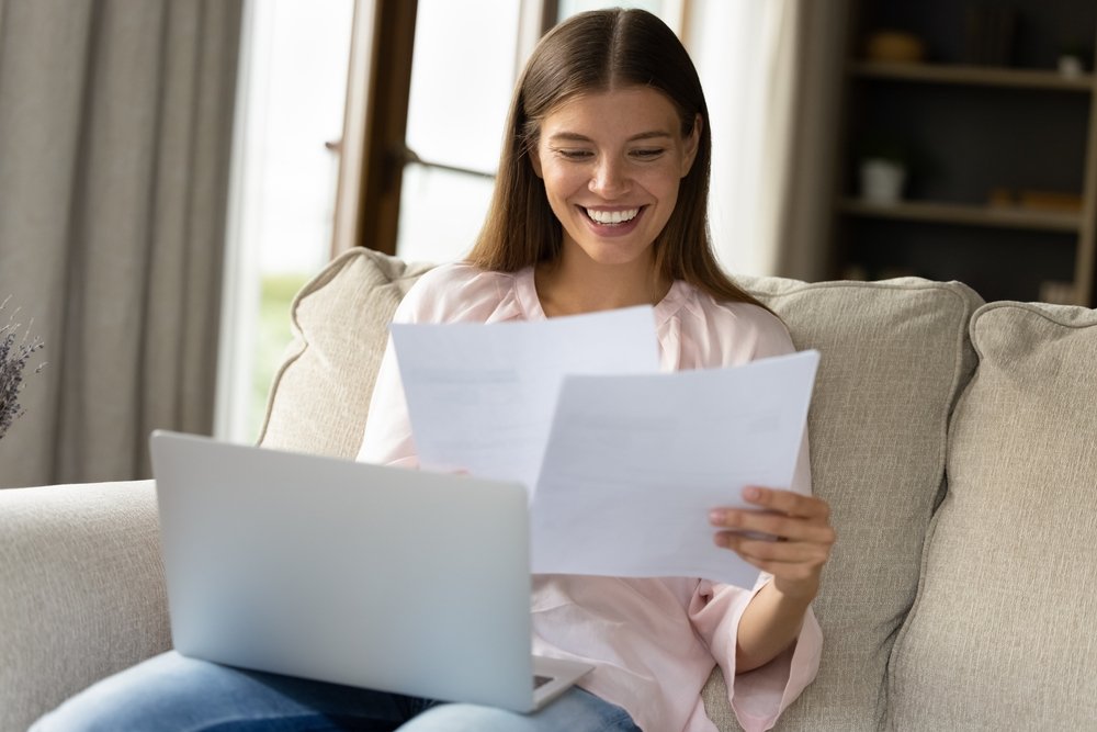 How Much Money Can You Really Make Working Remotely?: A picture showing a work from home lady in happy mood over remote work paycheck.