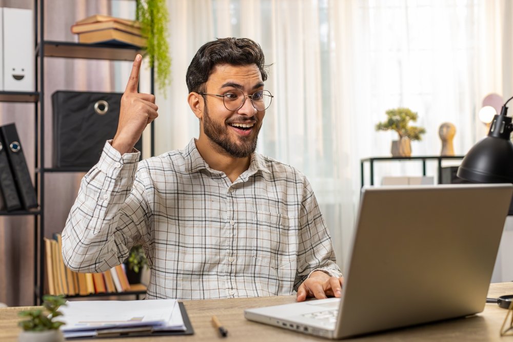 Finding Remote Work Opportunities: A picture of a male freelancer rejoicing on getting work opportunity