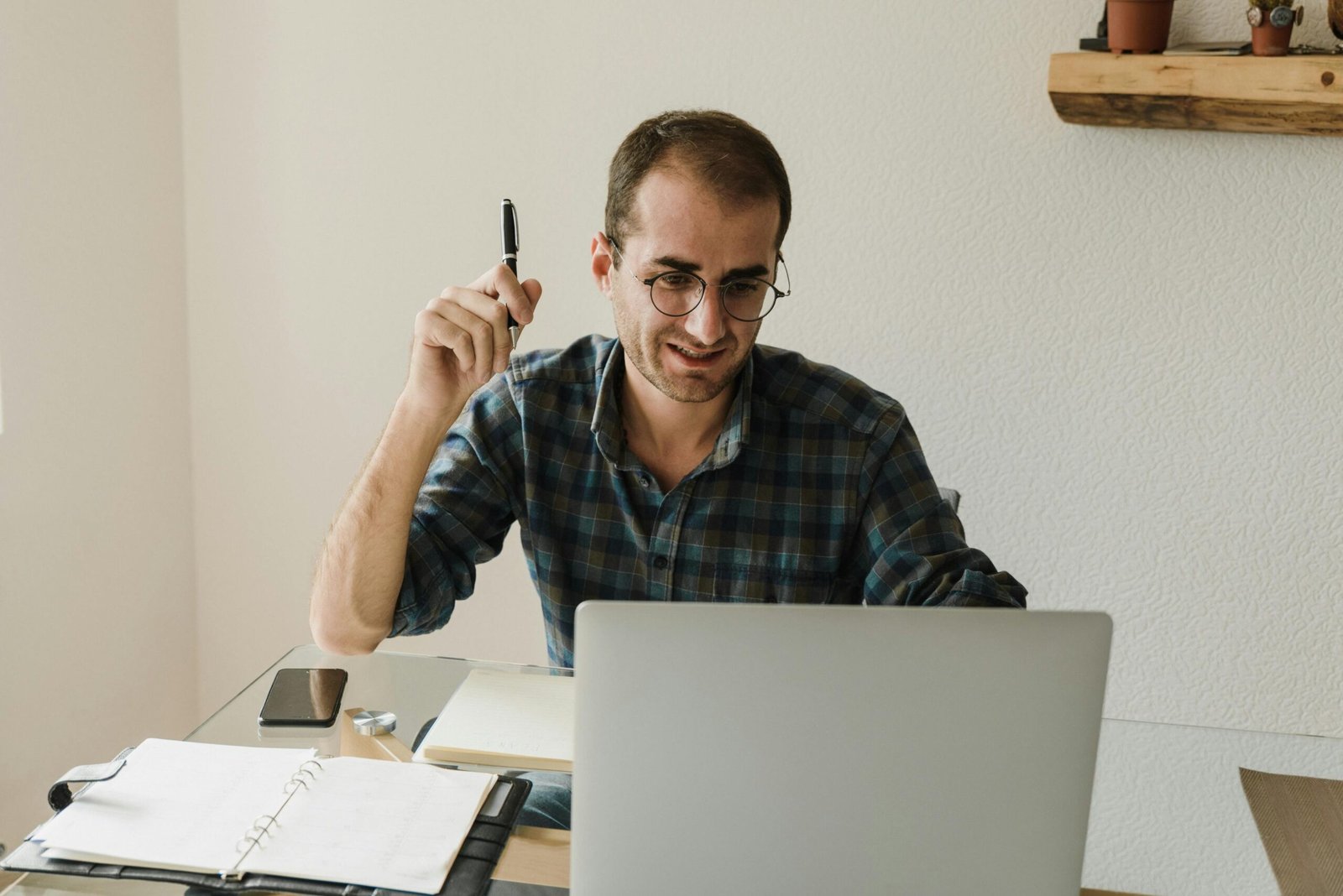 Remote Work Blunders: Image of a young man sitting at the office table working on a project