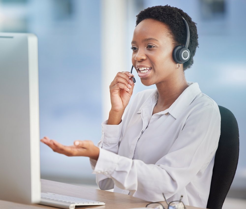 Remote Data Entry: Picture of a customer support staff working at desk of an online telemarketing business.
