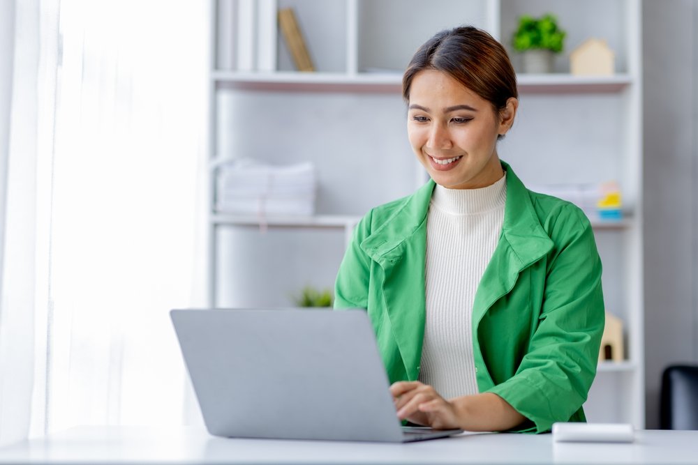 Remote Work Policies: Picture of a lady freelancer working on her system.
