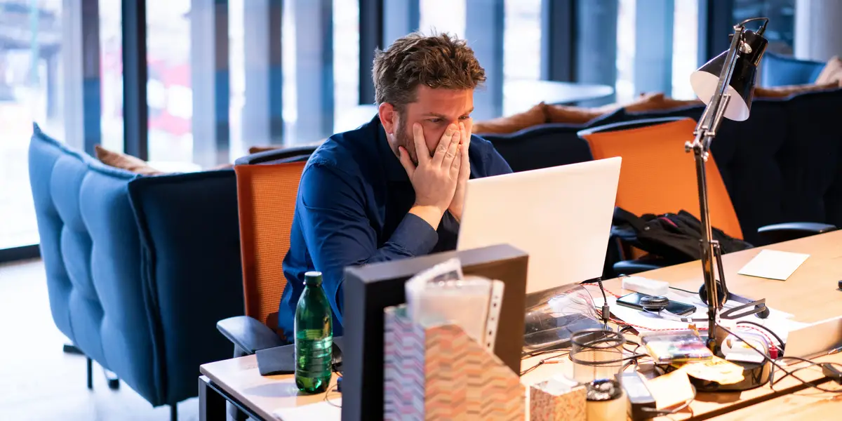 A remote worker that look frustrated: Amazon and AT&T want an end to remote work: Will 2025 finally be the death of WFH?