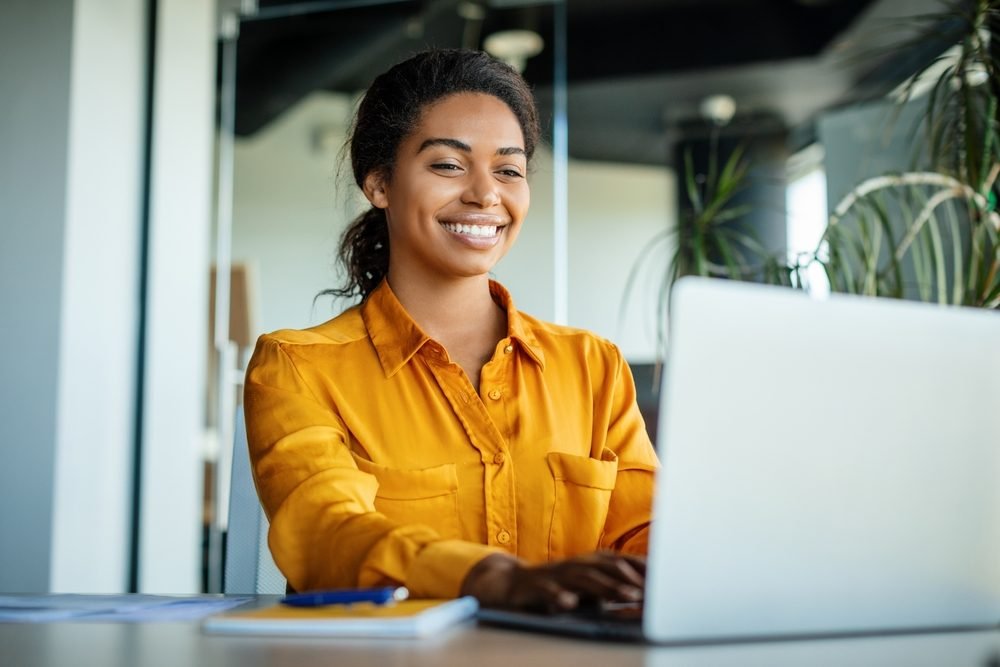 How Much Money Can You Really Make Working Remotely?: A picture showing a happy remote A picture showing a remote worker exploring opportunities in a job fair.