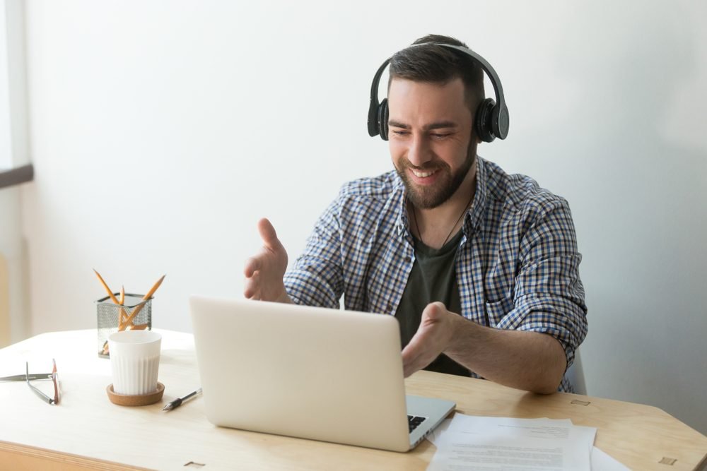 Amazon Remote Positions: A man working from home with an headset on his head