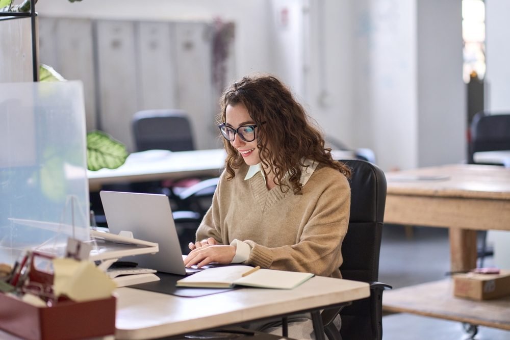 Pinterest Remote Jobs: A young lady working from her home through her laptop
