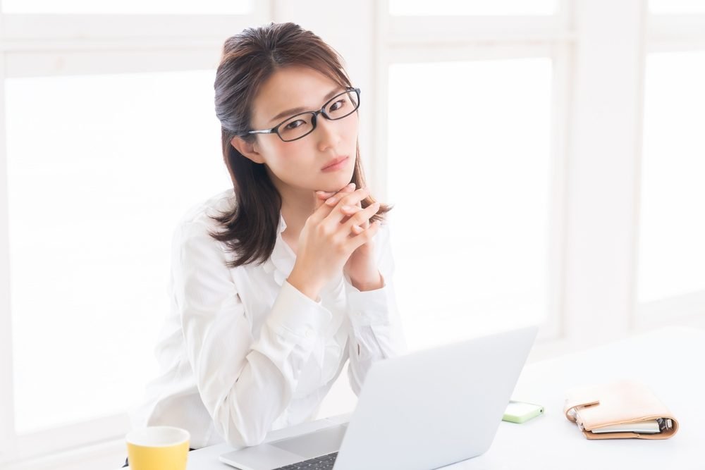 Appen Remote Jobs: A young lady sitting and working remotely, from her home.