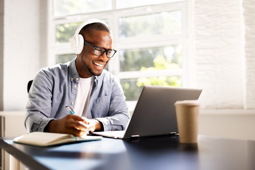 cvs work from home jobs: A picture of a young man working remotely from home office